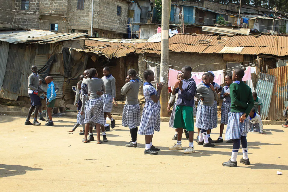 Children playing together outside their school in Mathare