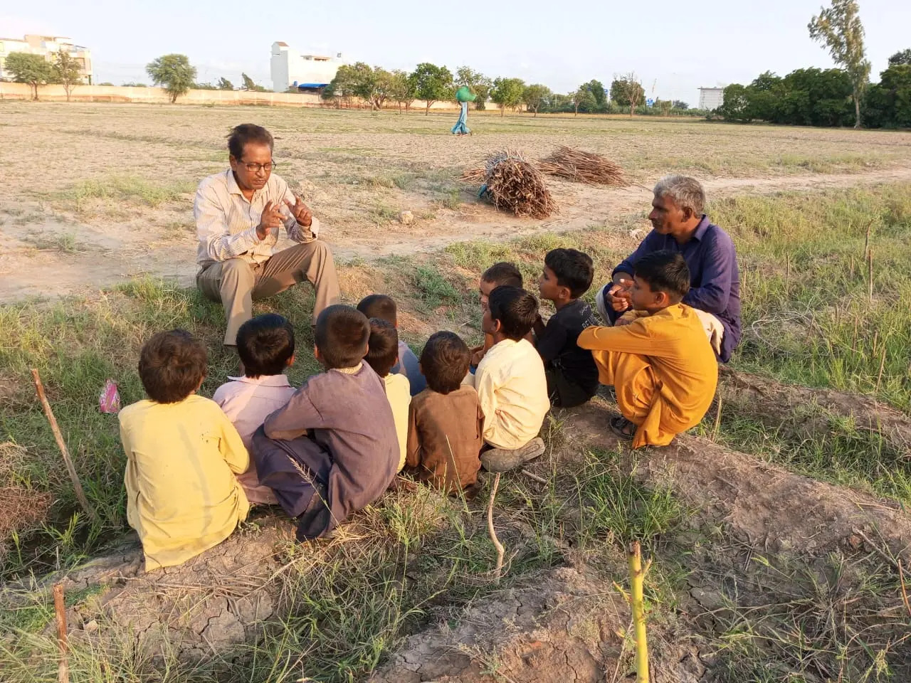Children gathered for a lesson in a field in rural Pakistan